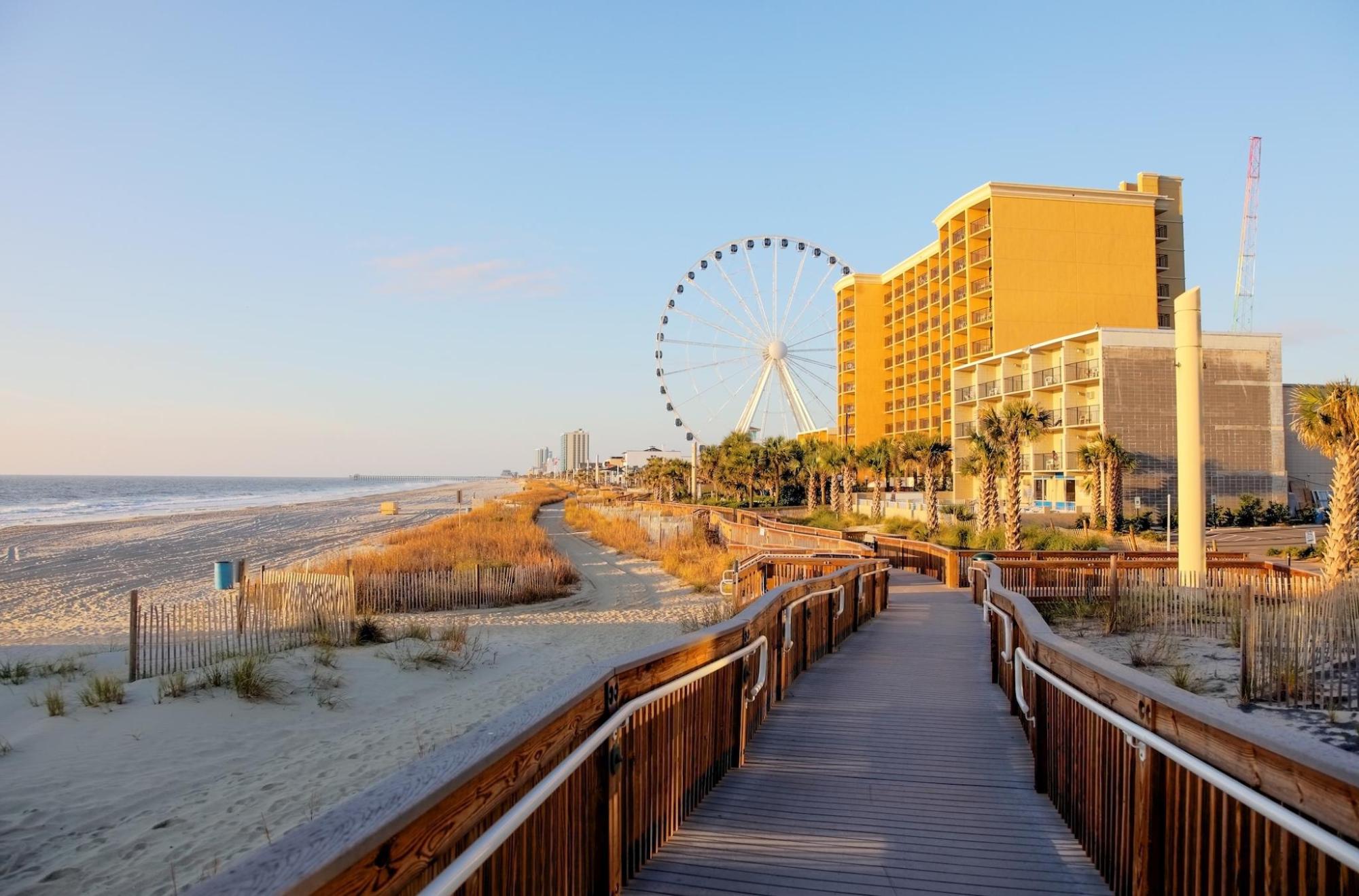 Myrtle Beach's boardwalk leads to the beach & a ferris wheel