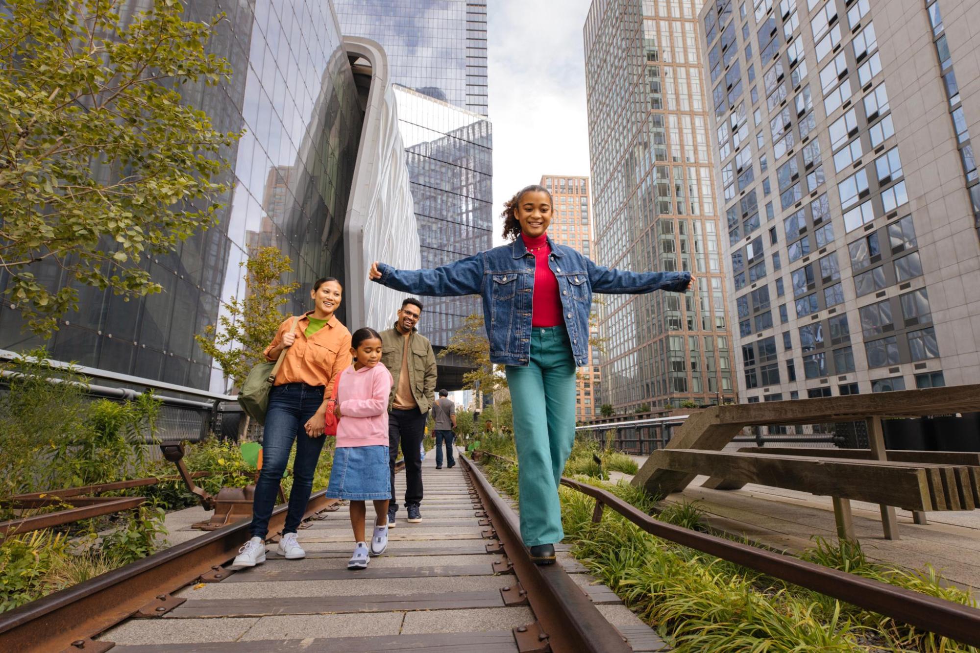 A family enjoys a stroll on the High Line walkway