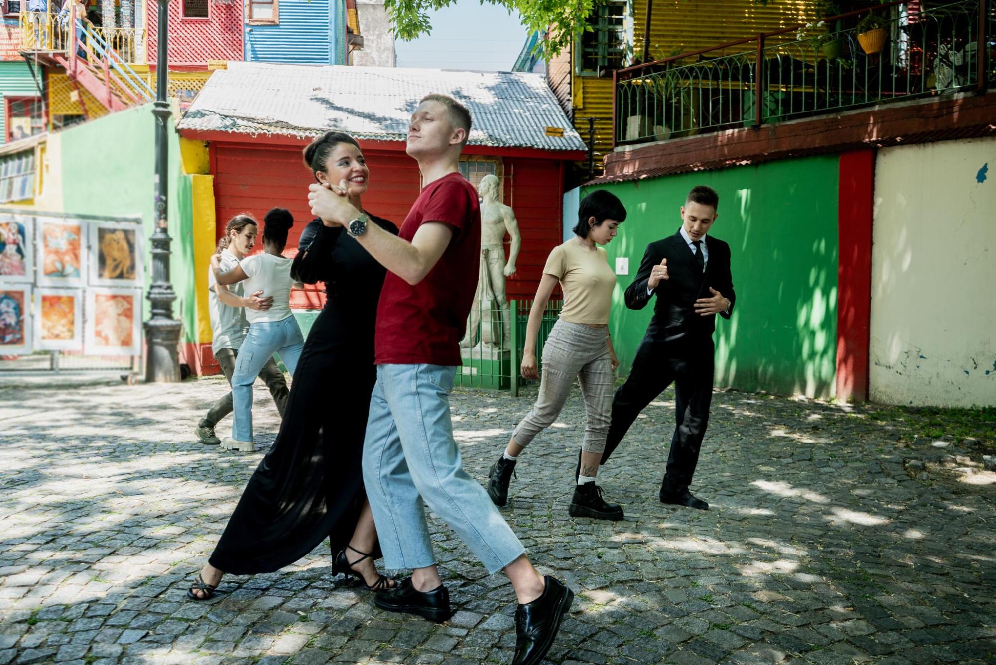 A man and woman dance the tango in a town square