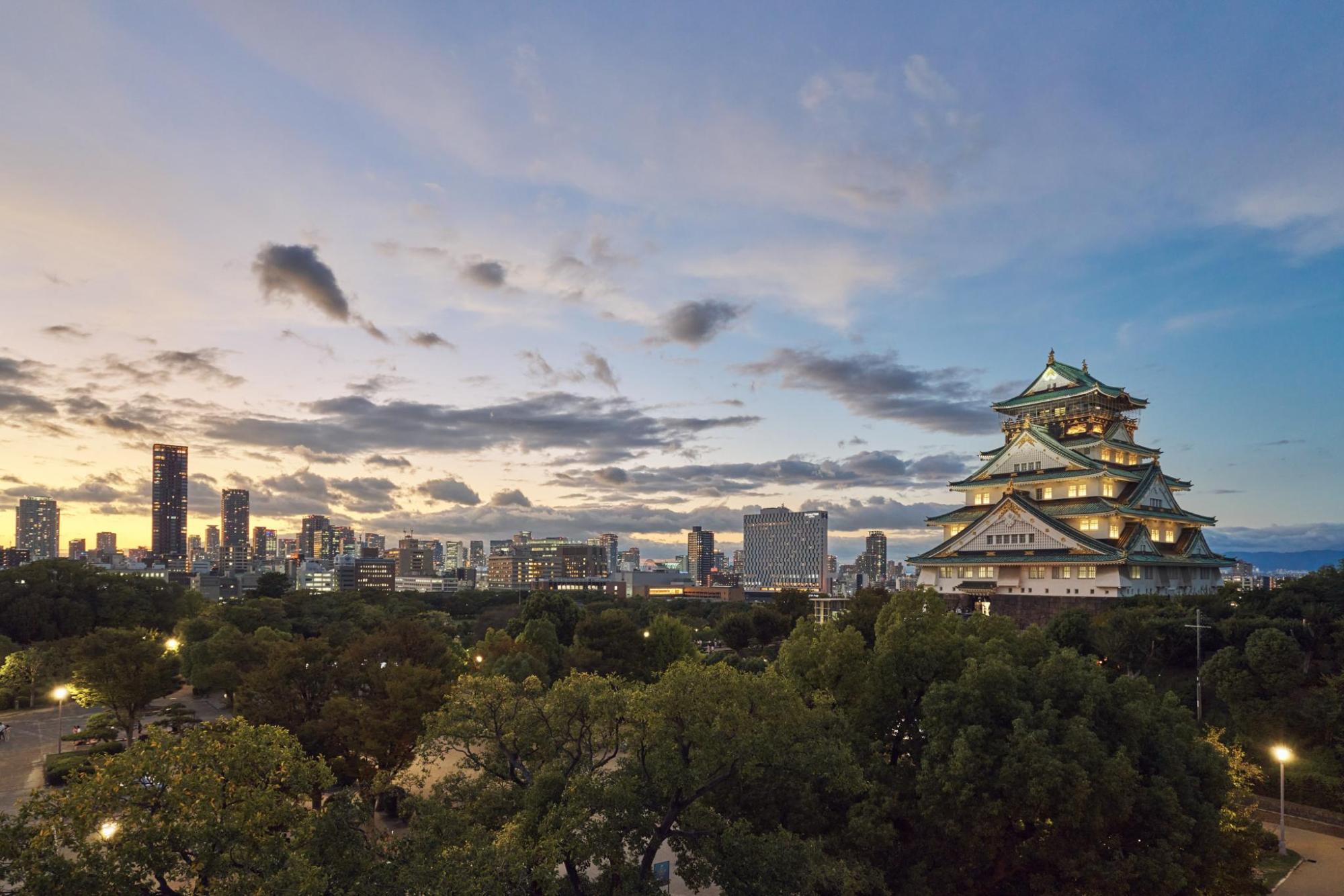 Osaka city skyline glowing at sunset with vibrant colors.