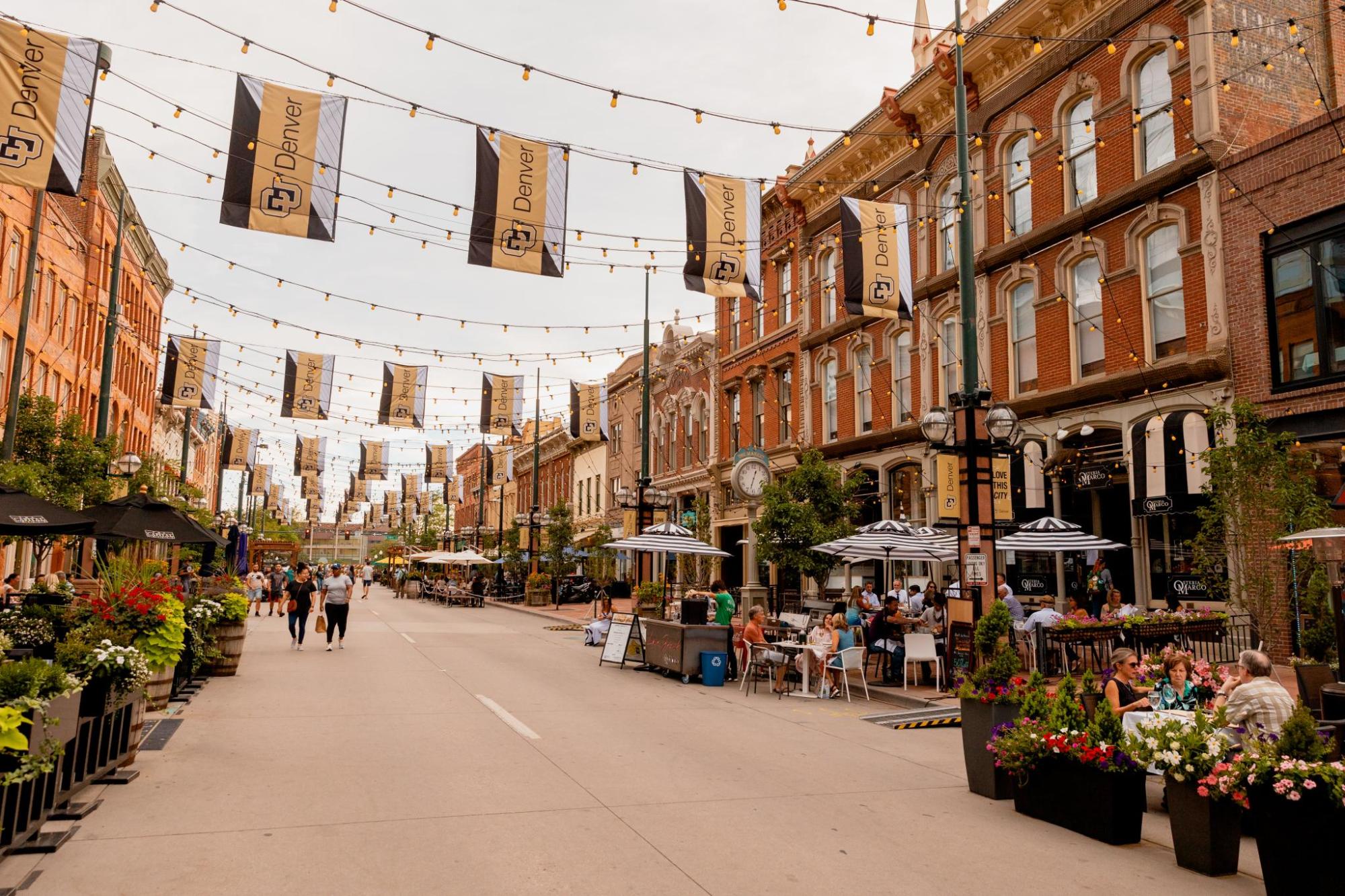 Outdoor dining and people along a lively Denver street