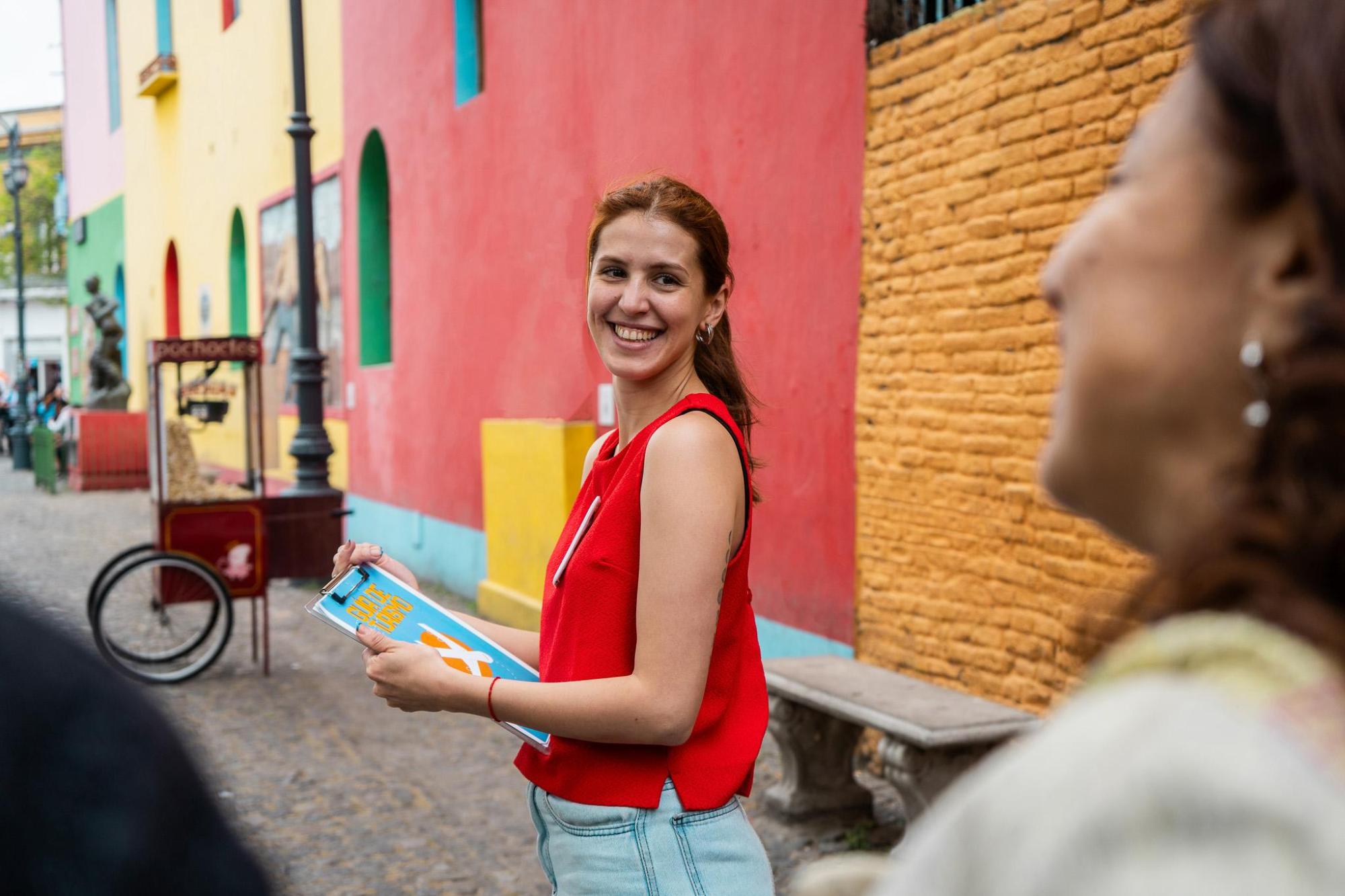 A smiling woman holding a clipboard 