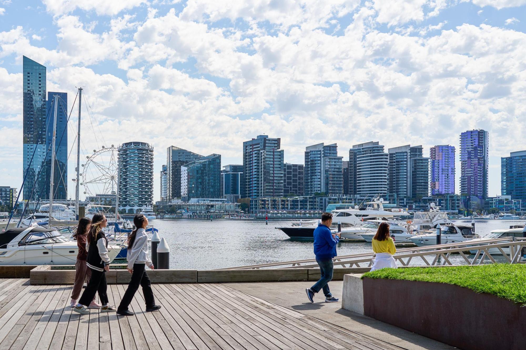 People walking along a river waterfront