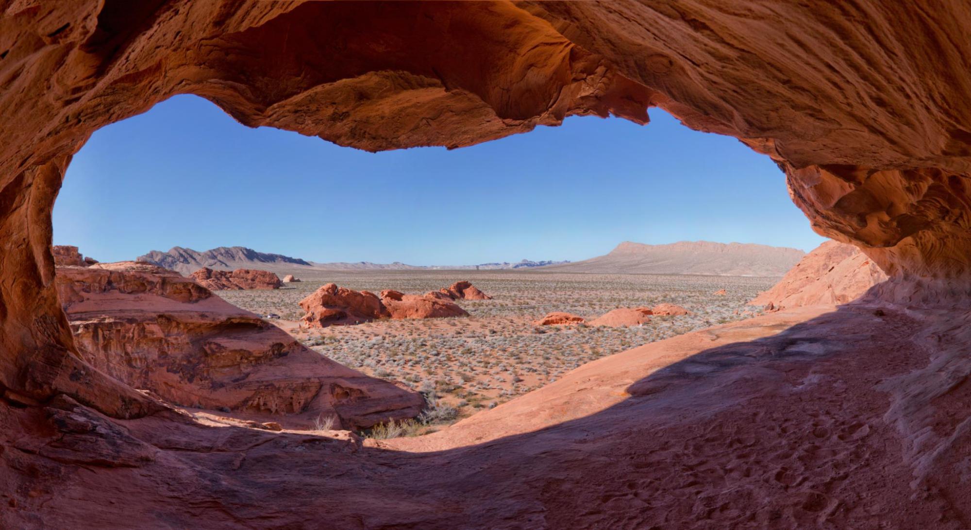 Desert landscape viewed through a sandstone cave opening