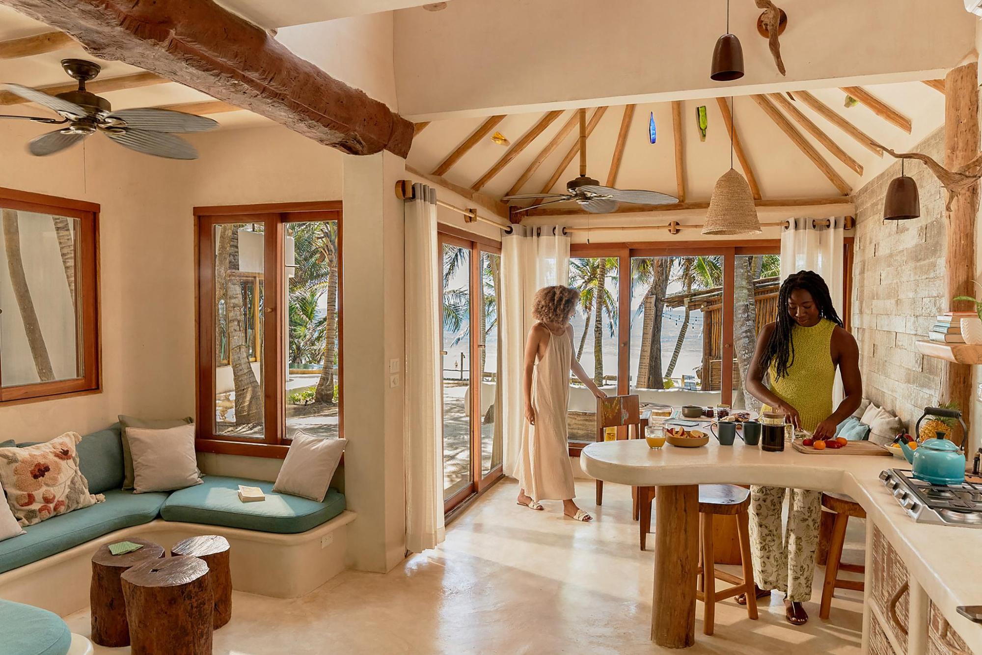 Two women in a beachside villa kitchen