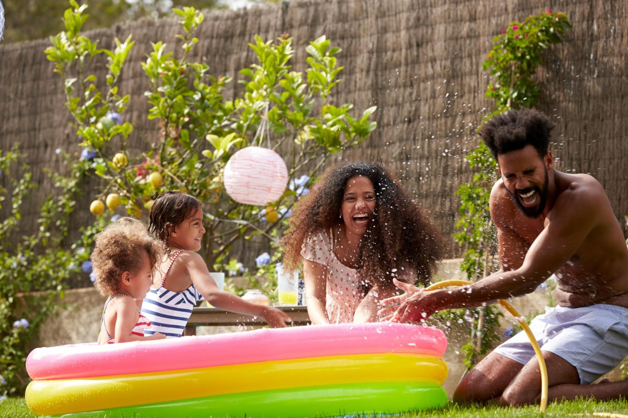  A family enjoys a sunny day playing in an inflatable pool