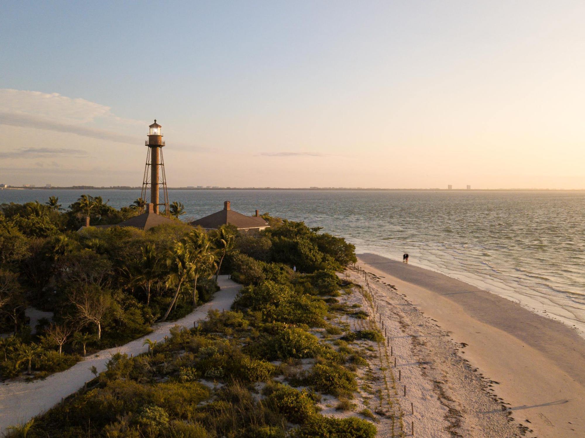 A scenic beach in Florida featuring a tall lighthouse