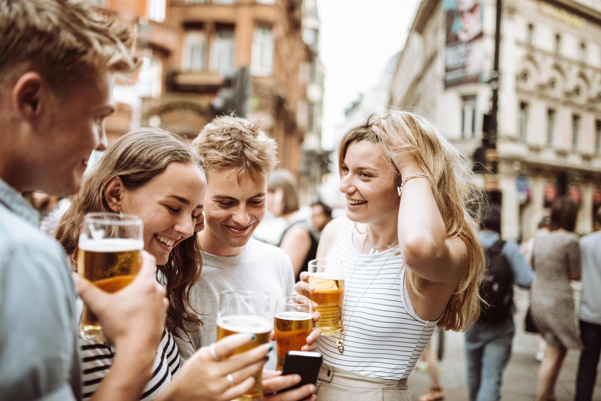People enjoying beers together at an outdoor bar