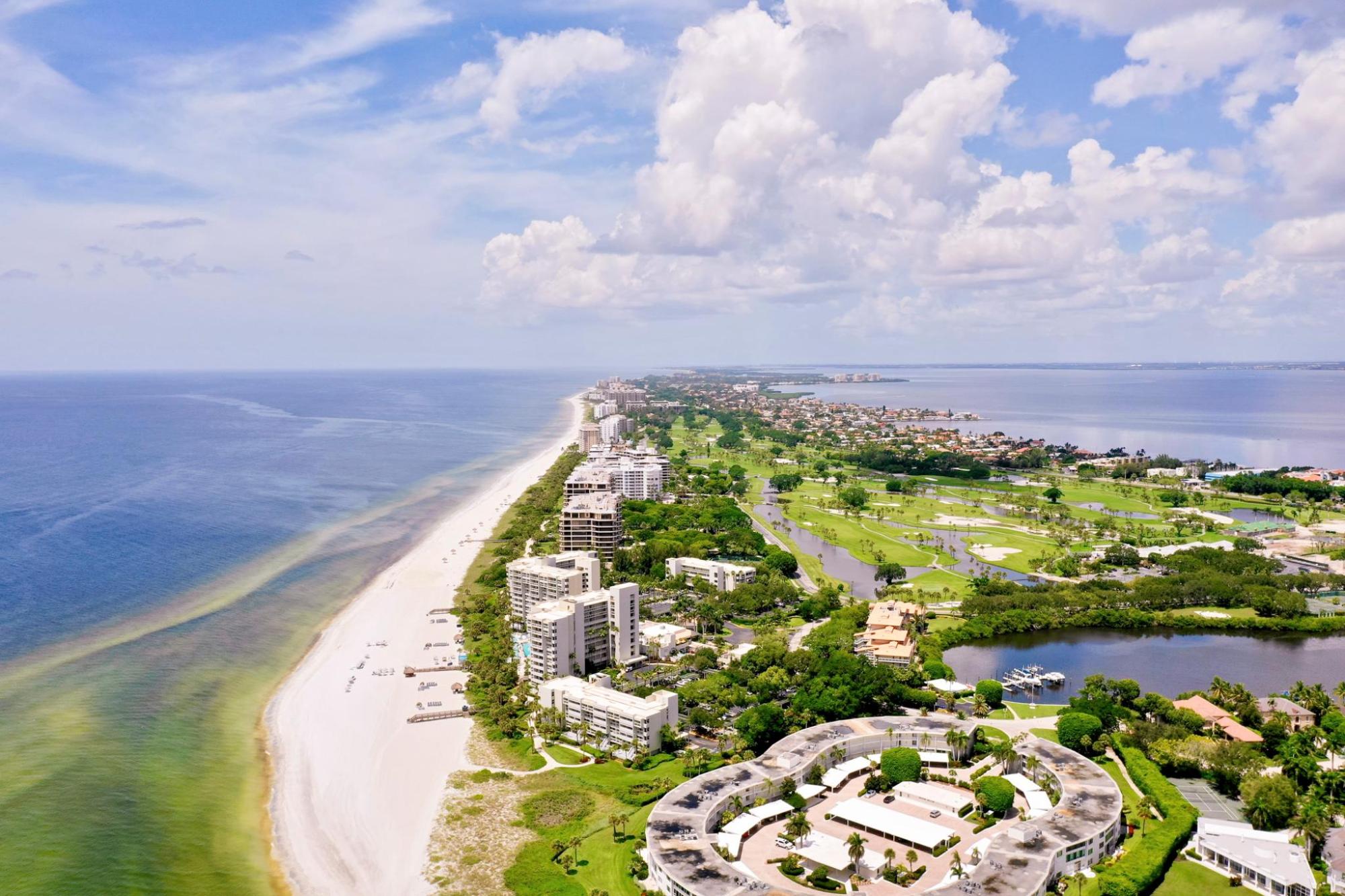 Aerial view of a long sandy beach and coastal resorts