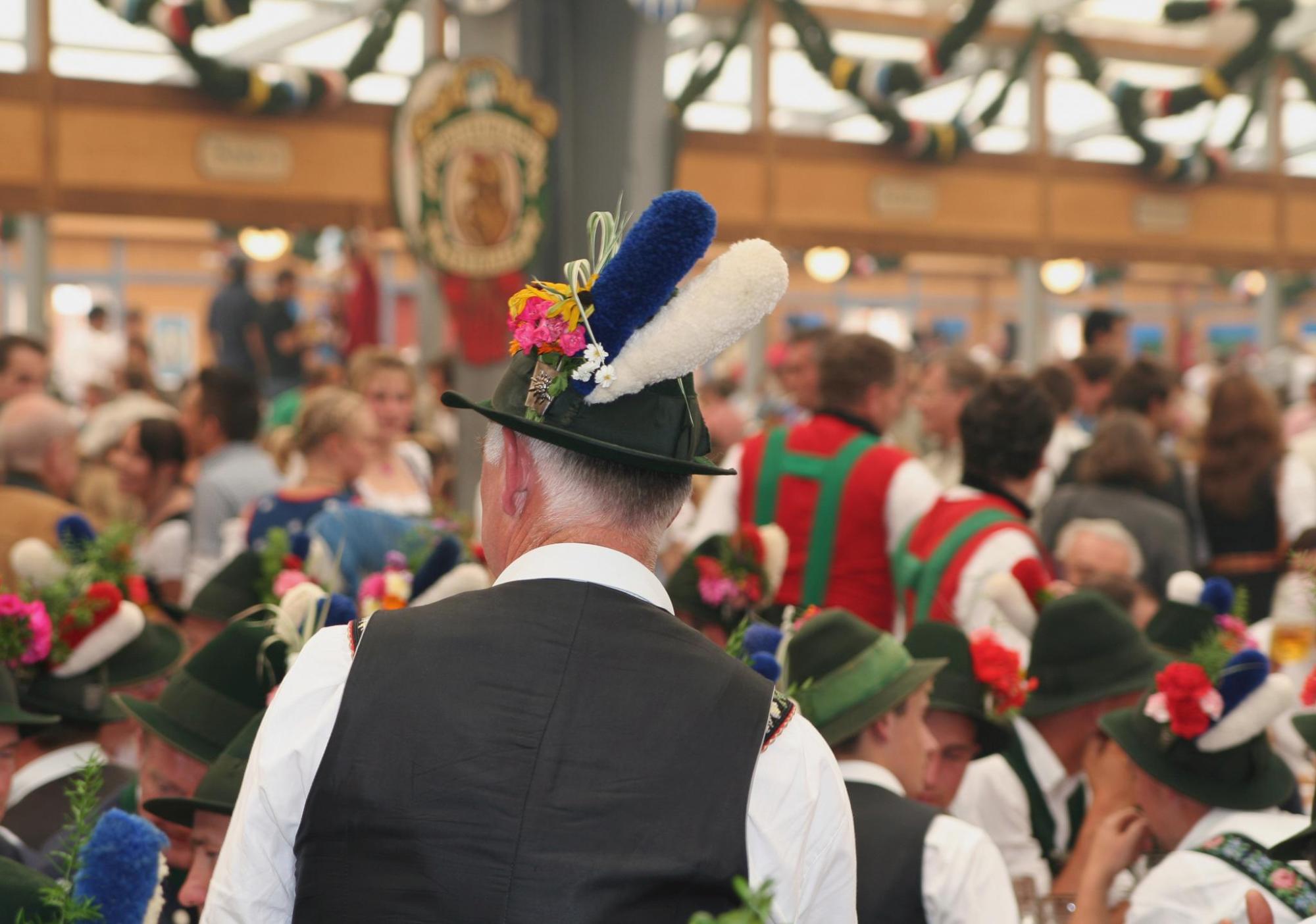 Visitors in classic Bavarian dress in an Oktoberfest tent.