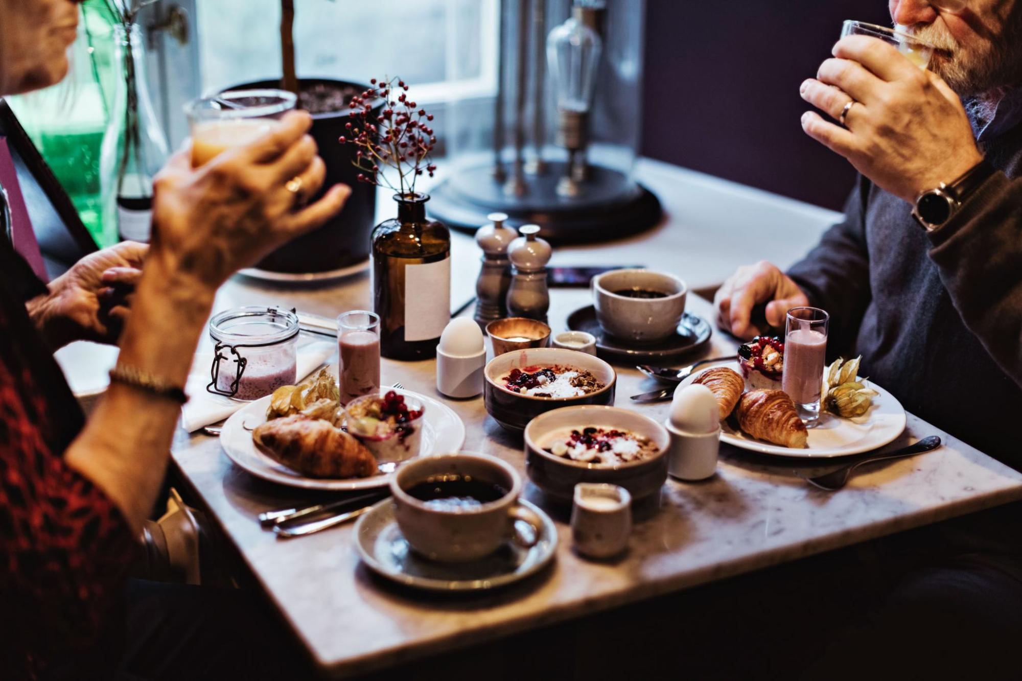 Two people enjoying breakfast together at an accommodation