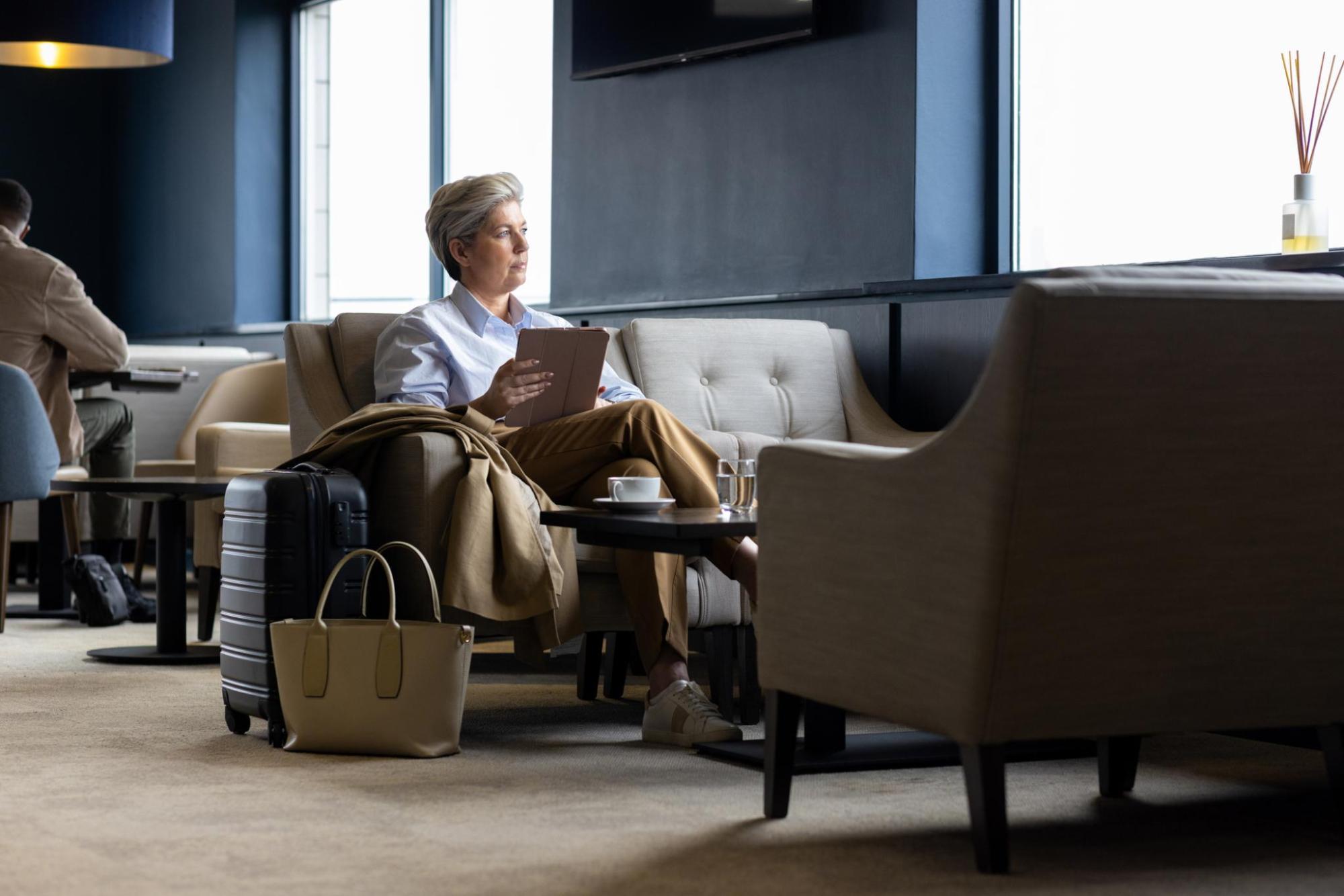 Woman waiting for her flight at the airport lounge