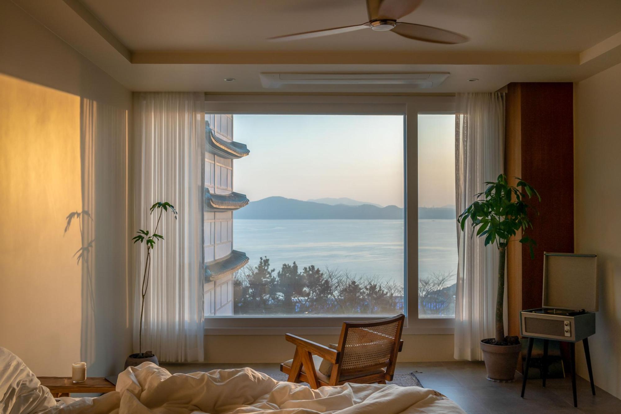A room with a window overlooking the sea in the morning